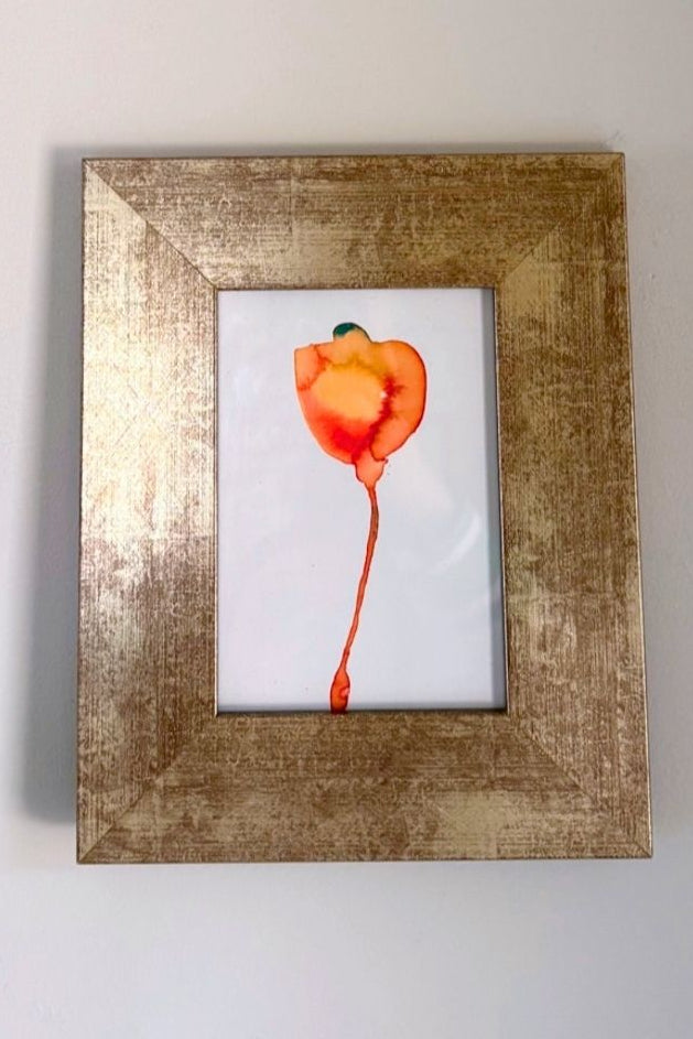 Framed art print of a tangerine bloom on a white wall with 'Tangerine Bloom Art Print' text above and website address below.